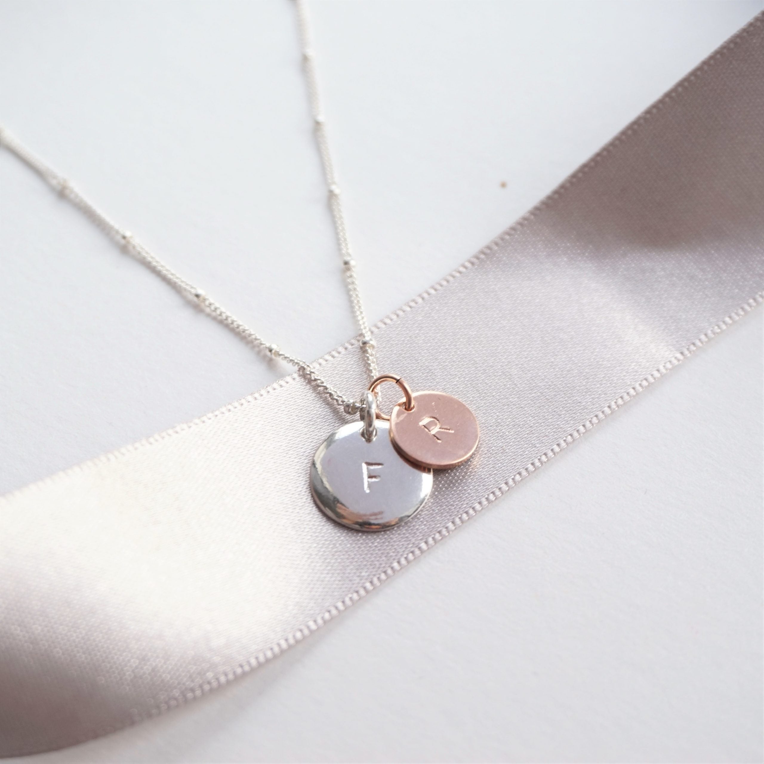 sterling silver necklace with stamped silver and rose gold discs