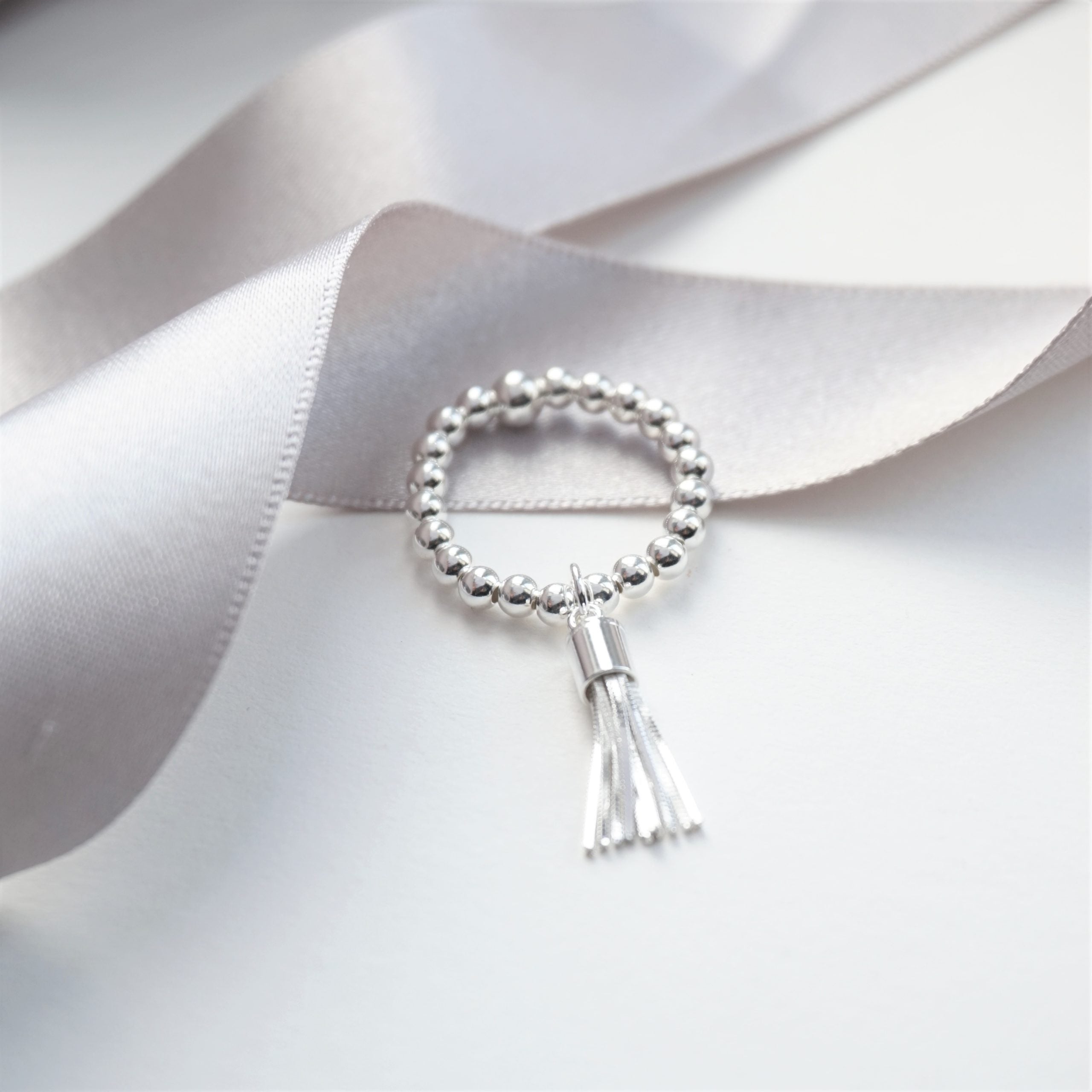 sterling silver ring with tassel charm