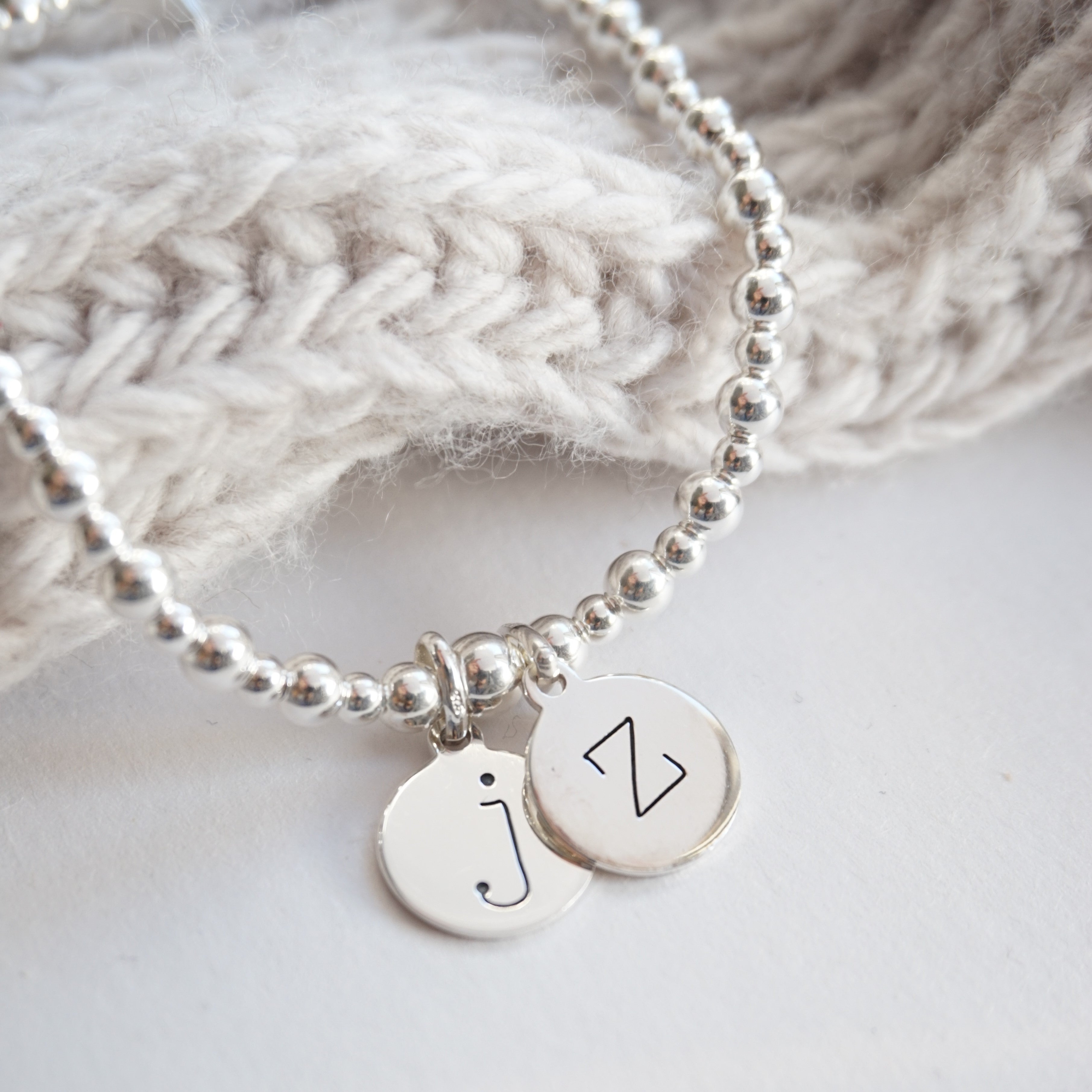 sterling silver bracelet with two lowercase initial charms