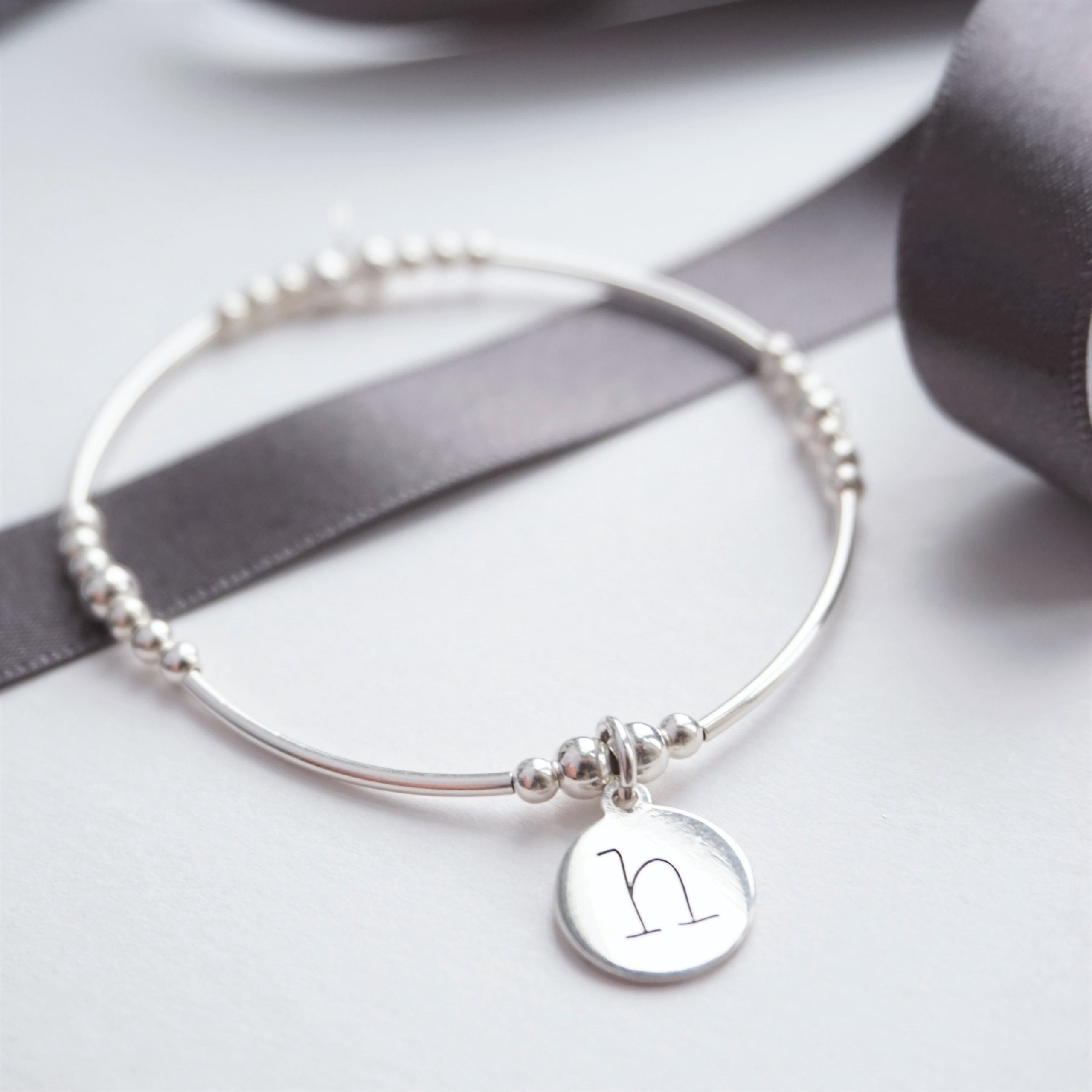 sterling silver noodle bracelet with lowercase initial