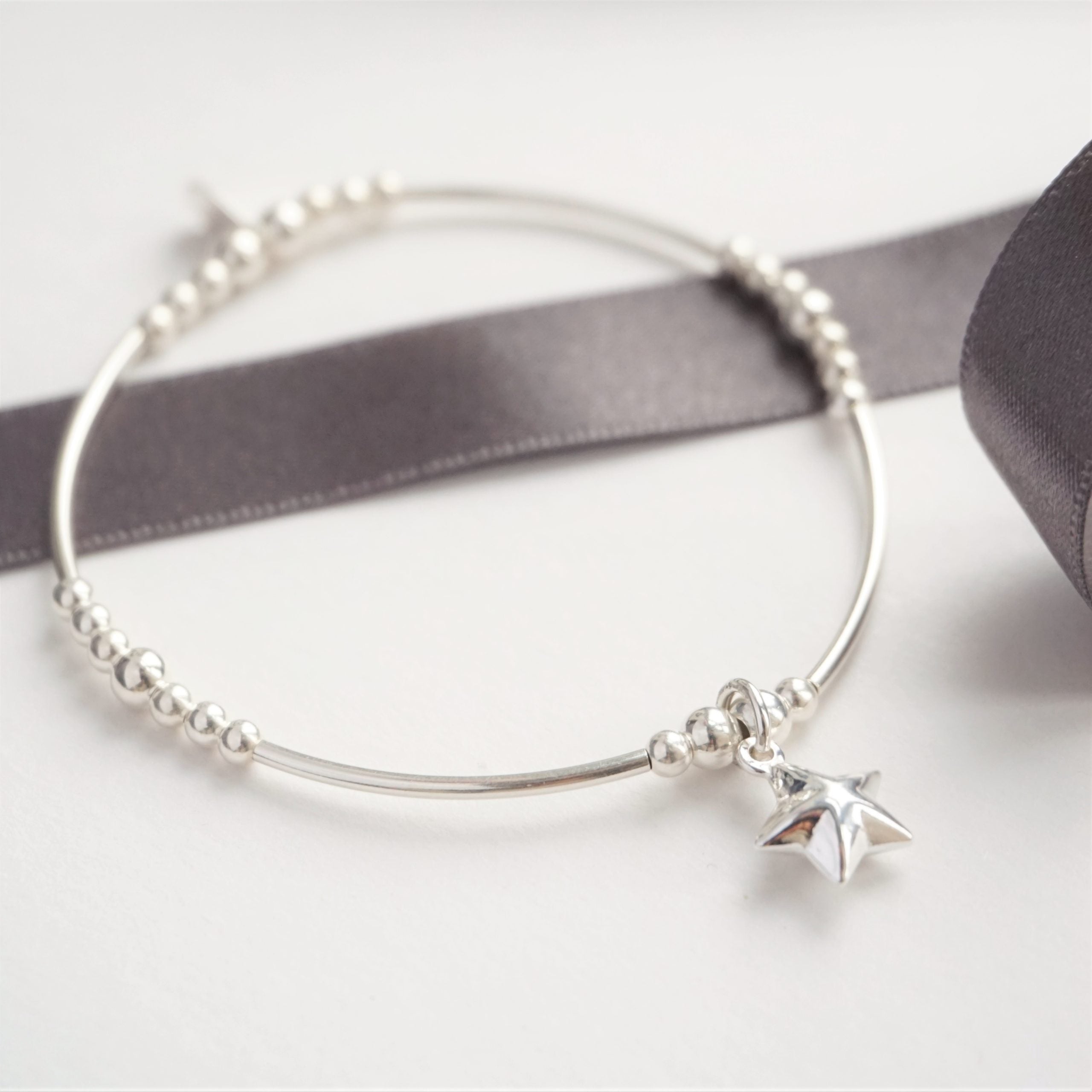 Sterling silver noodle bracelet with star charm