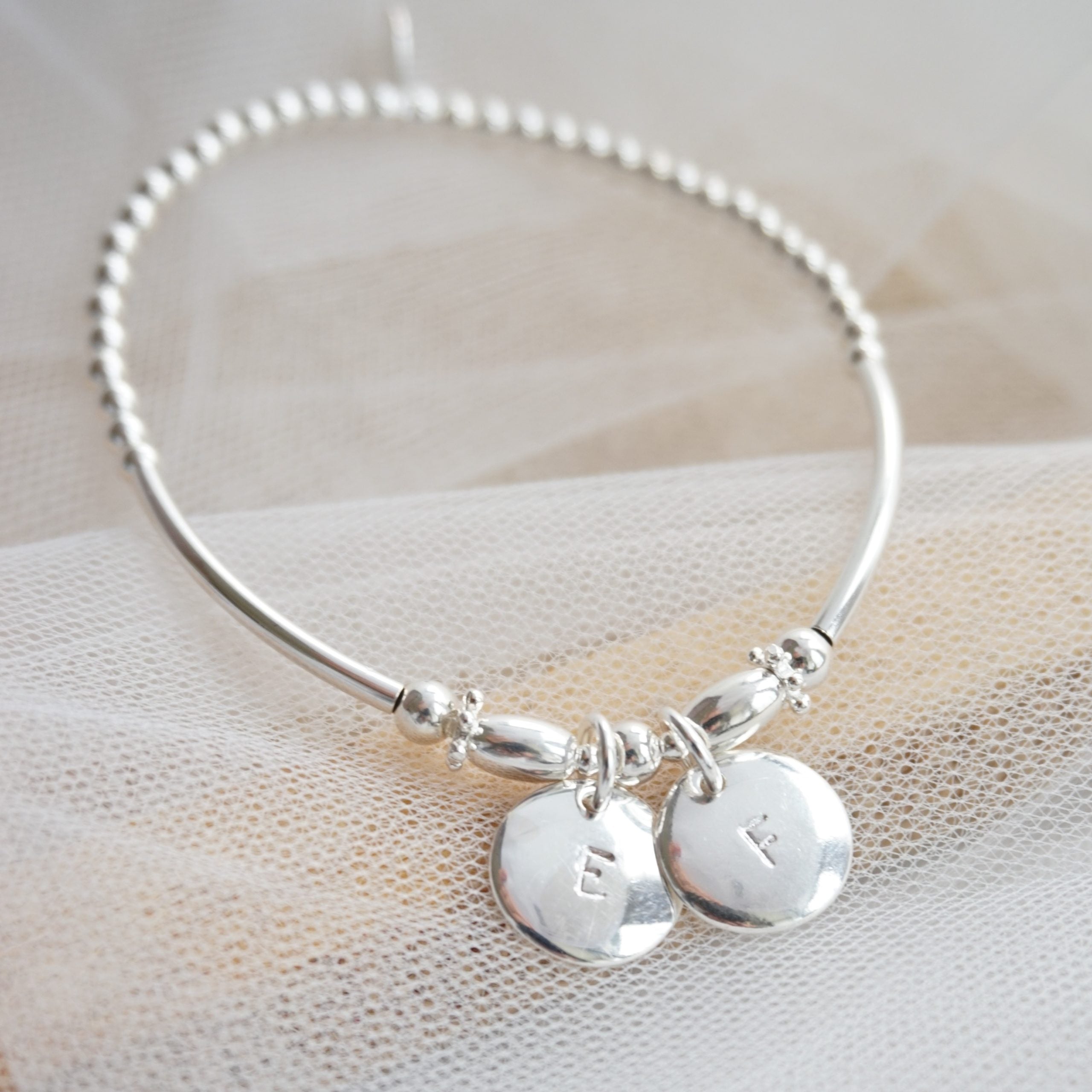 sterling silver beaded noodle bracelet with duo stamped discs