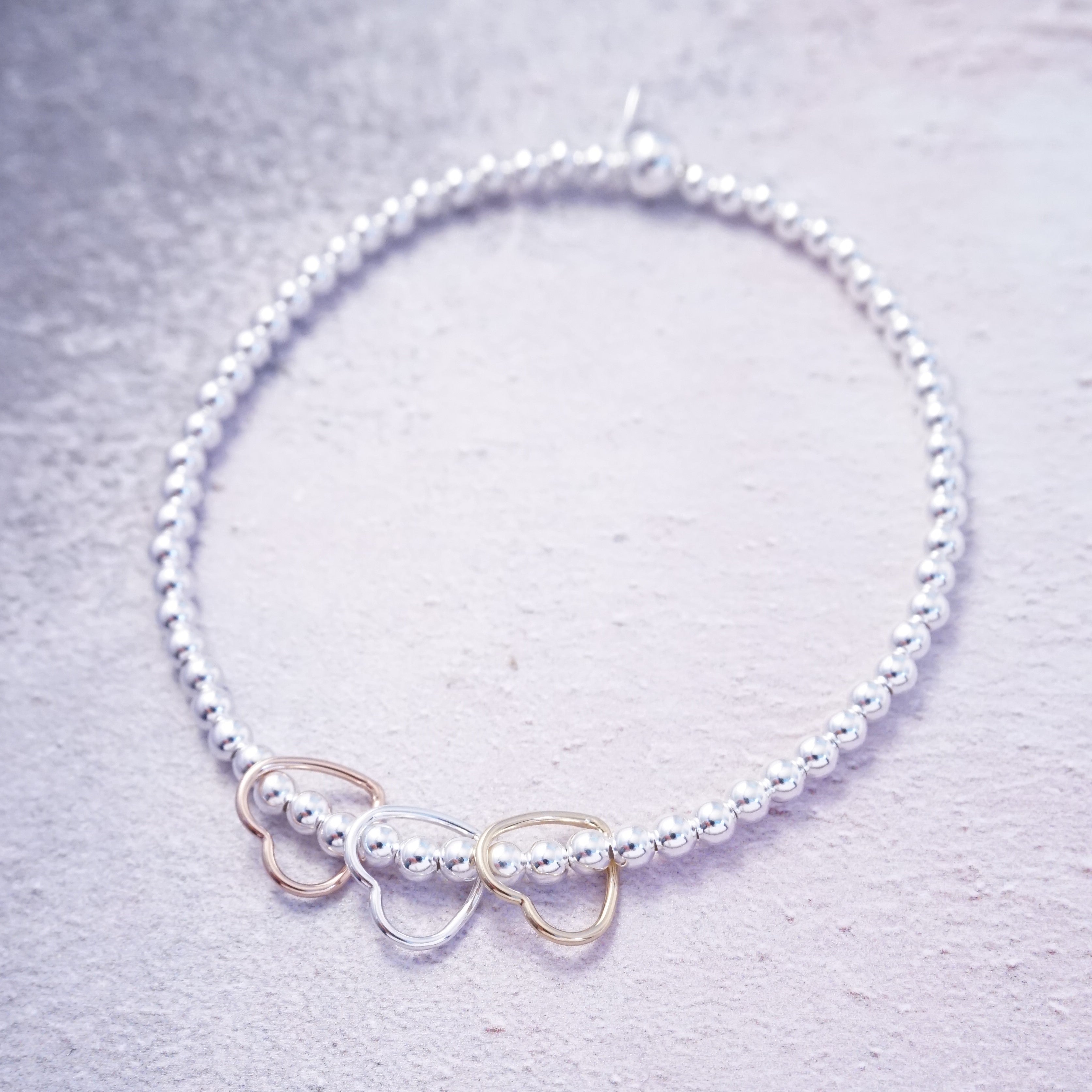 sterling silver rose gold and gold hearts stretch bracelet