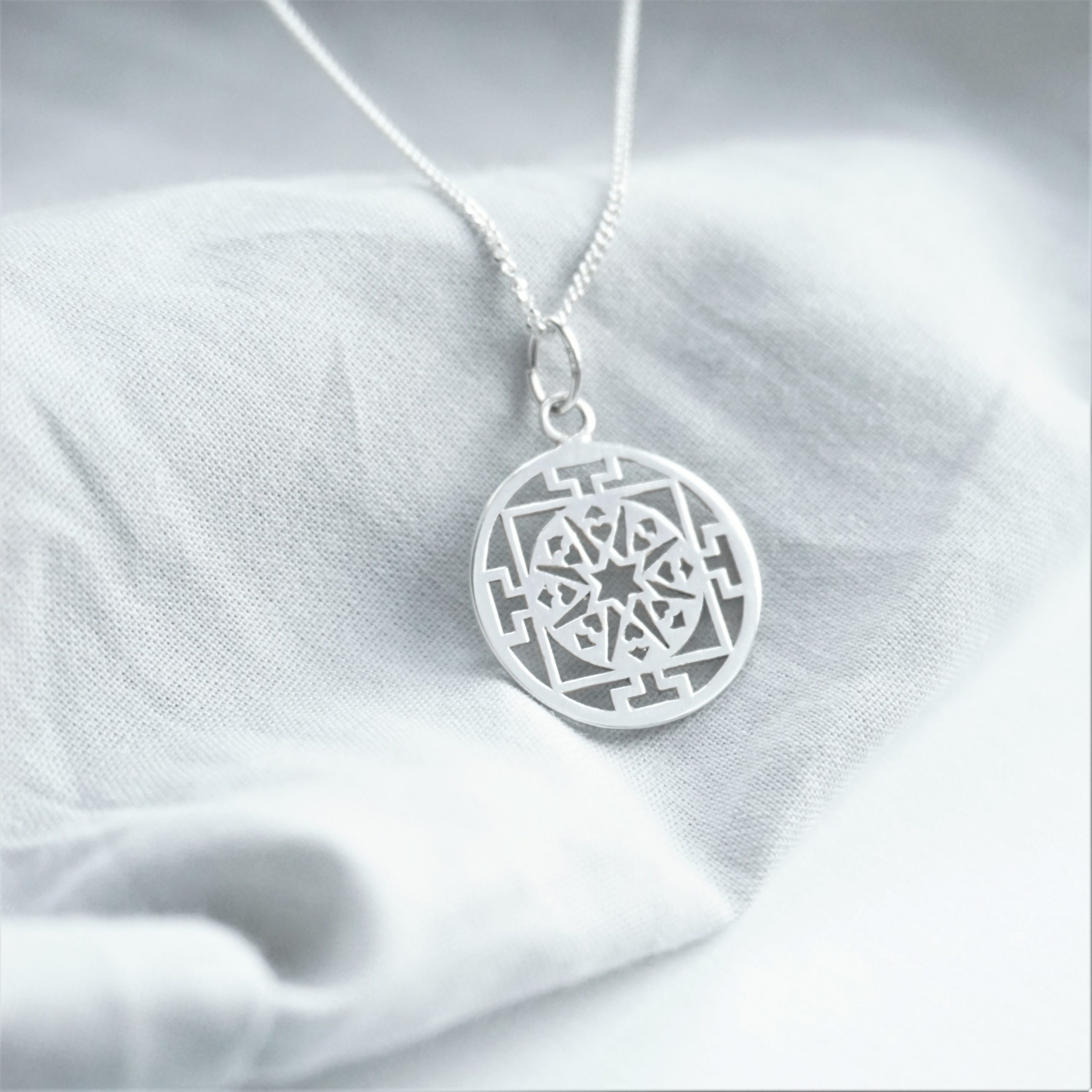 sterling silver necklace with circular design charm