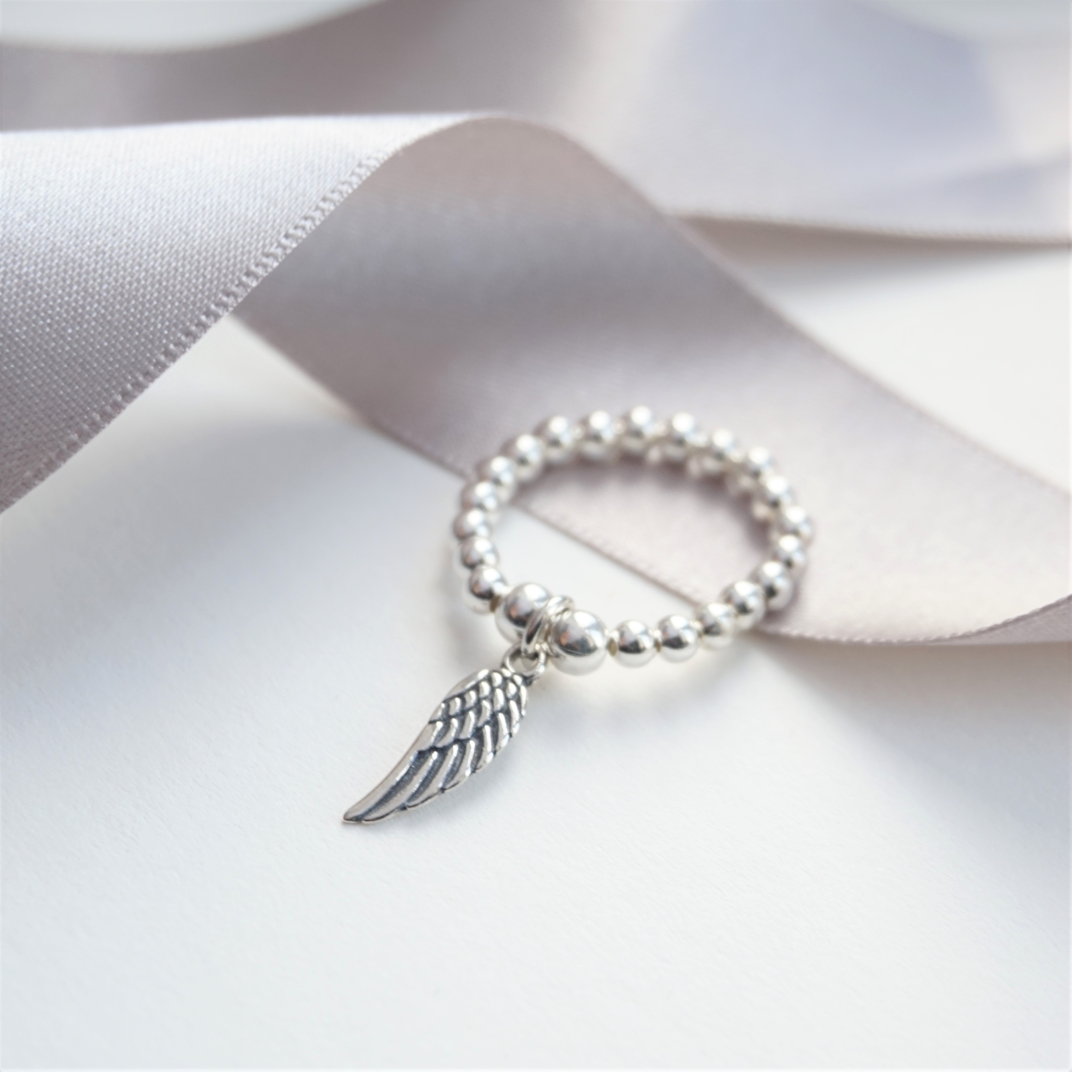 sterling silver ring with angel wing charm