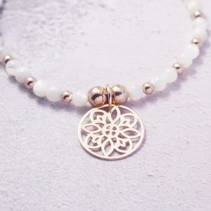 Rose Gold Stretch Bracelet with Mother of Pearl Beads and Circular Design Charm