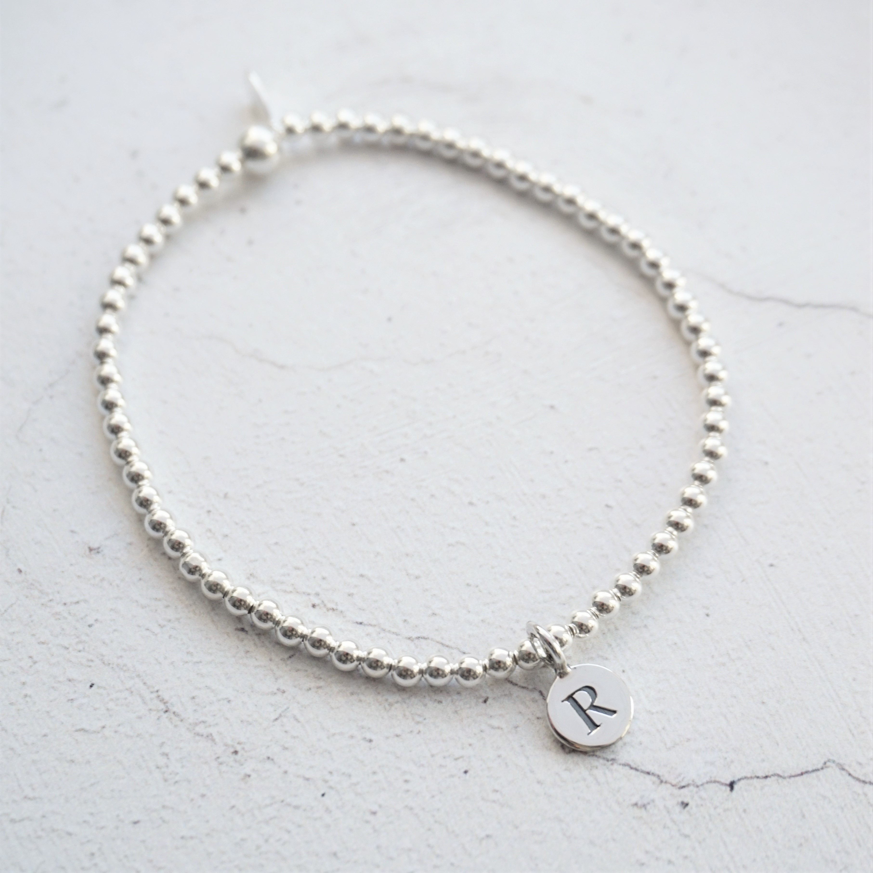 sterling silver bracelet with 1 small disc initial charm
