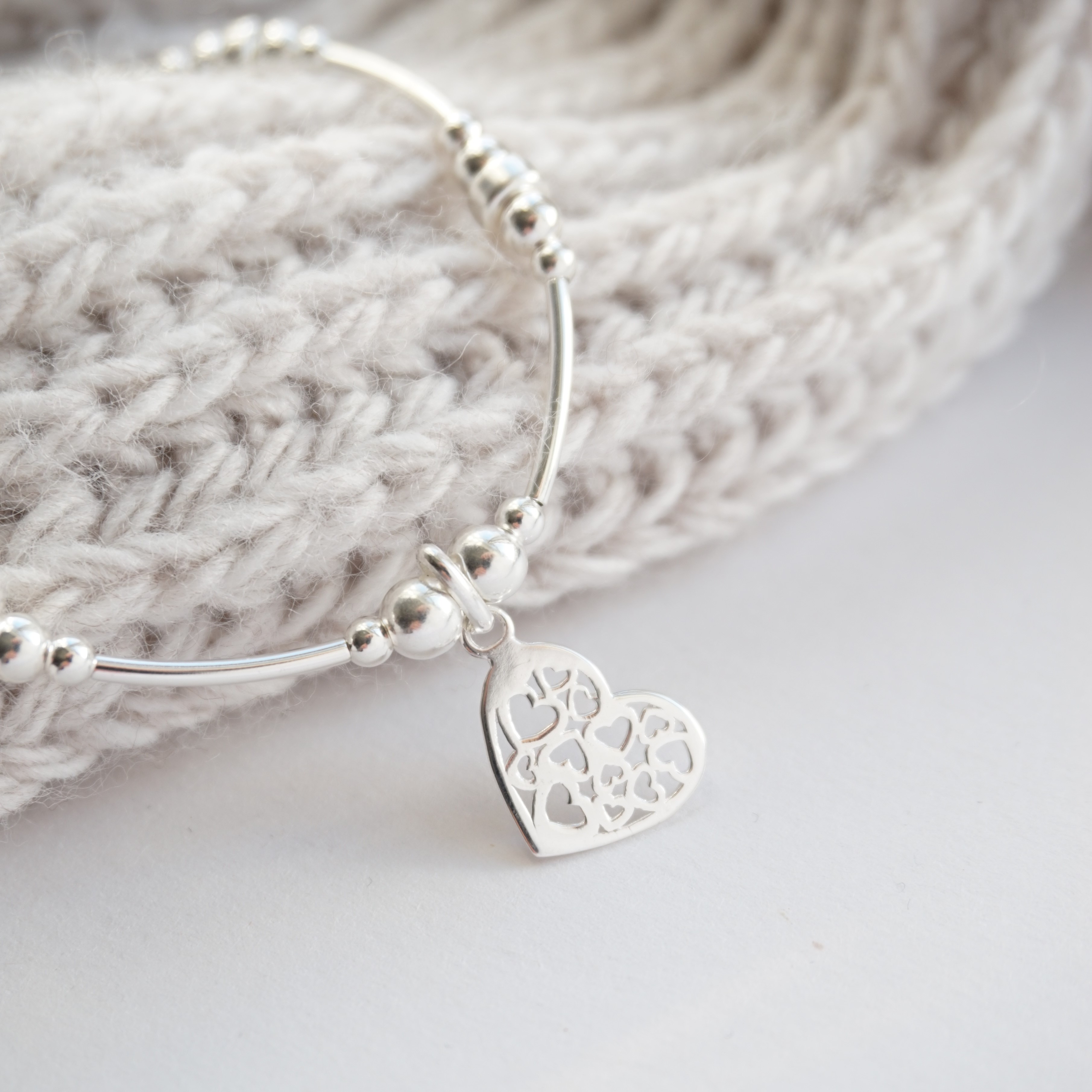 sterling silver noodle bracelet with hearts in heart charm