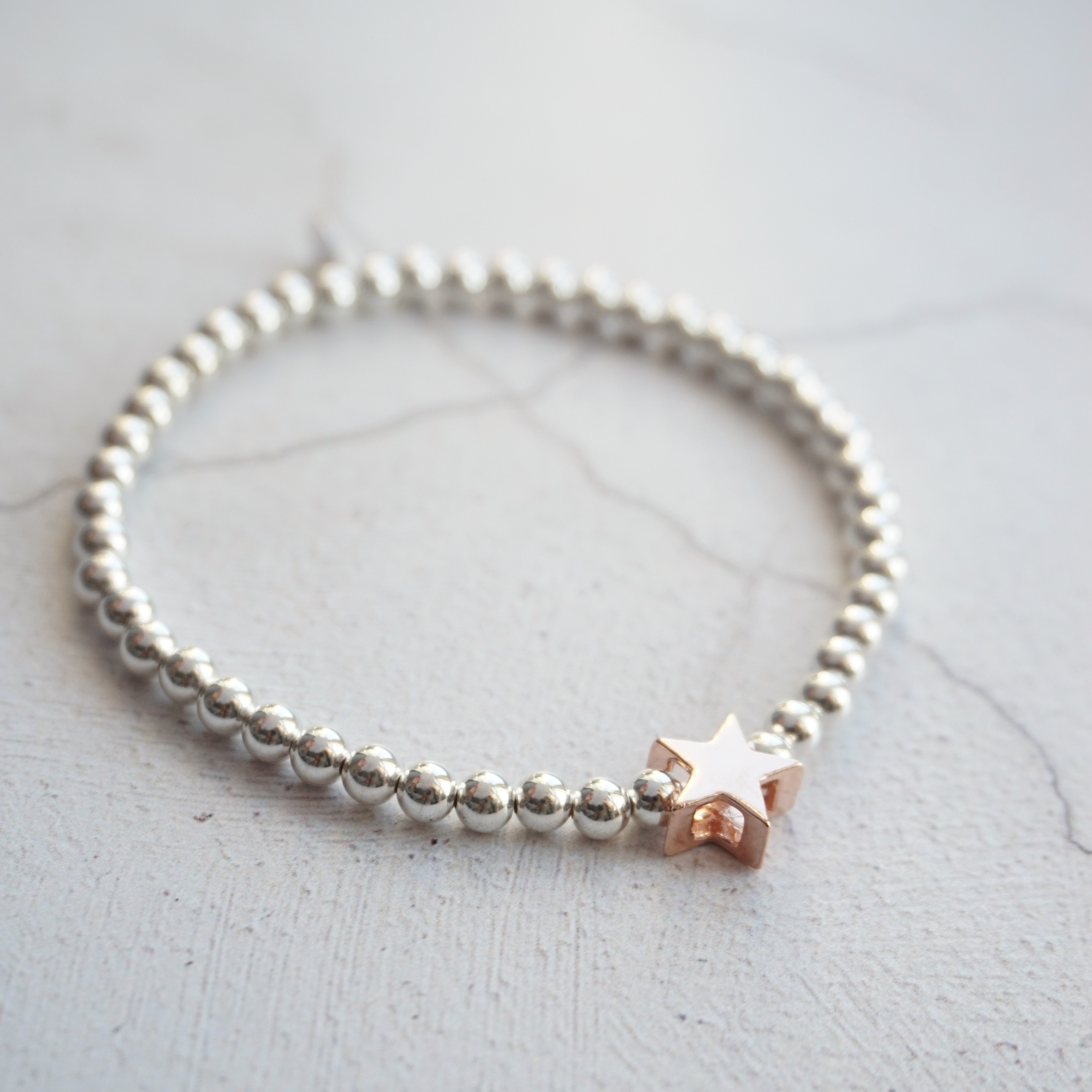 sterling silver bracelet with rose gold star bead