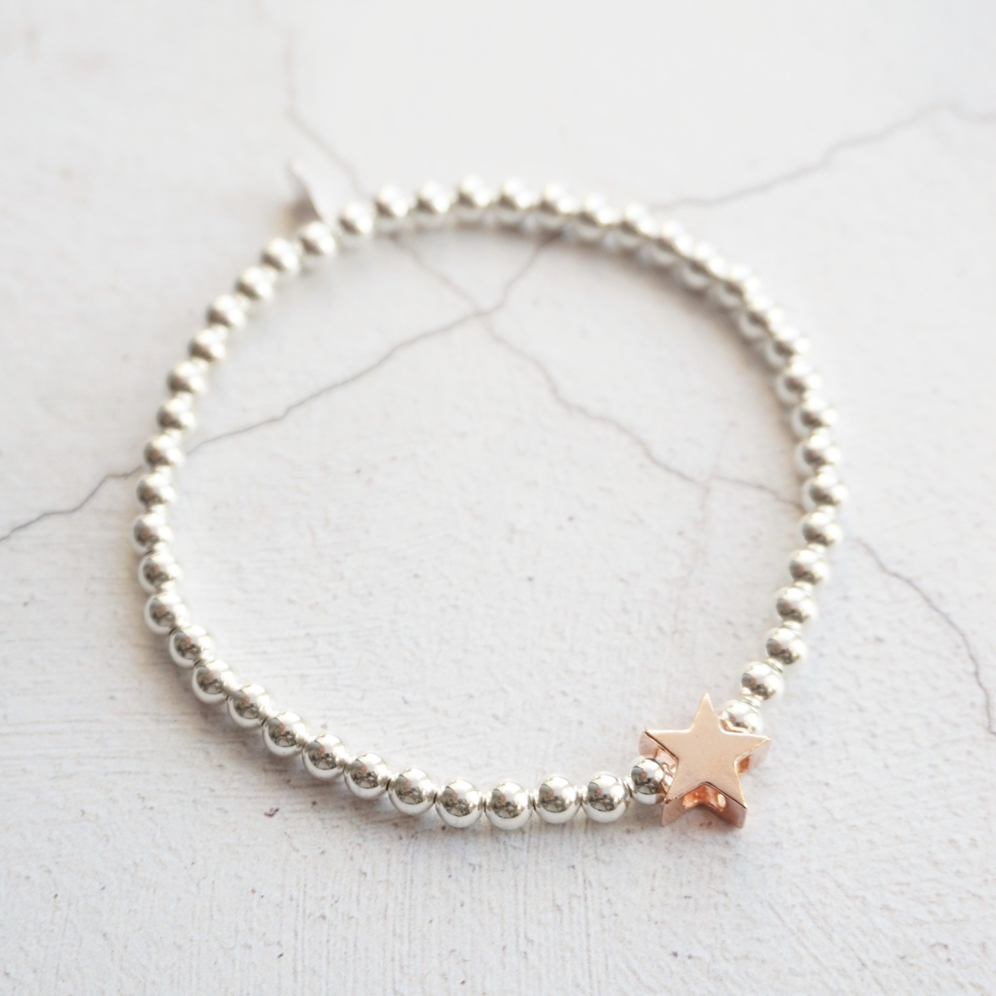 sterling silver bracelet with rose gold star bead