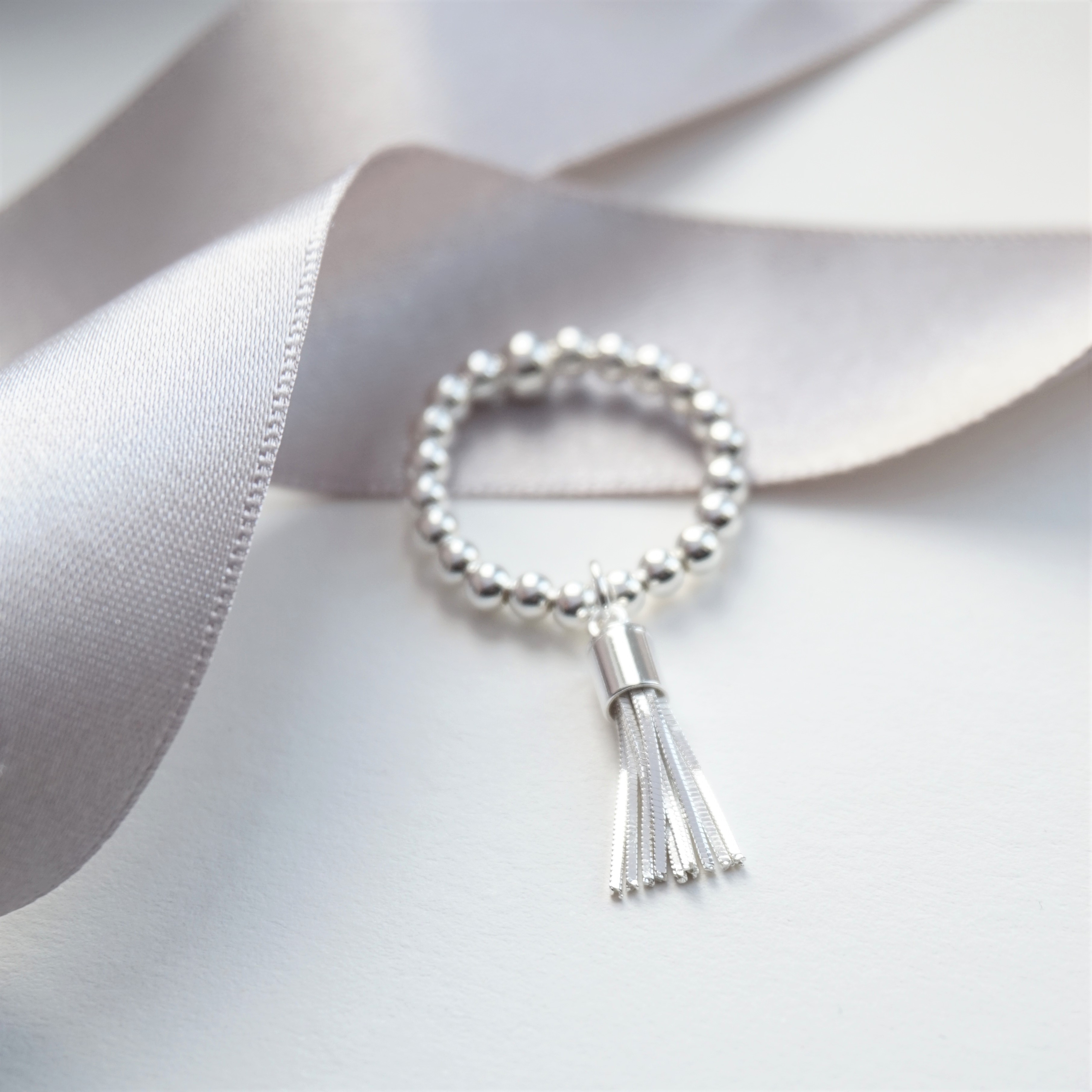 sterling silver ring with tassel charm