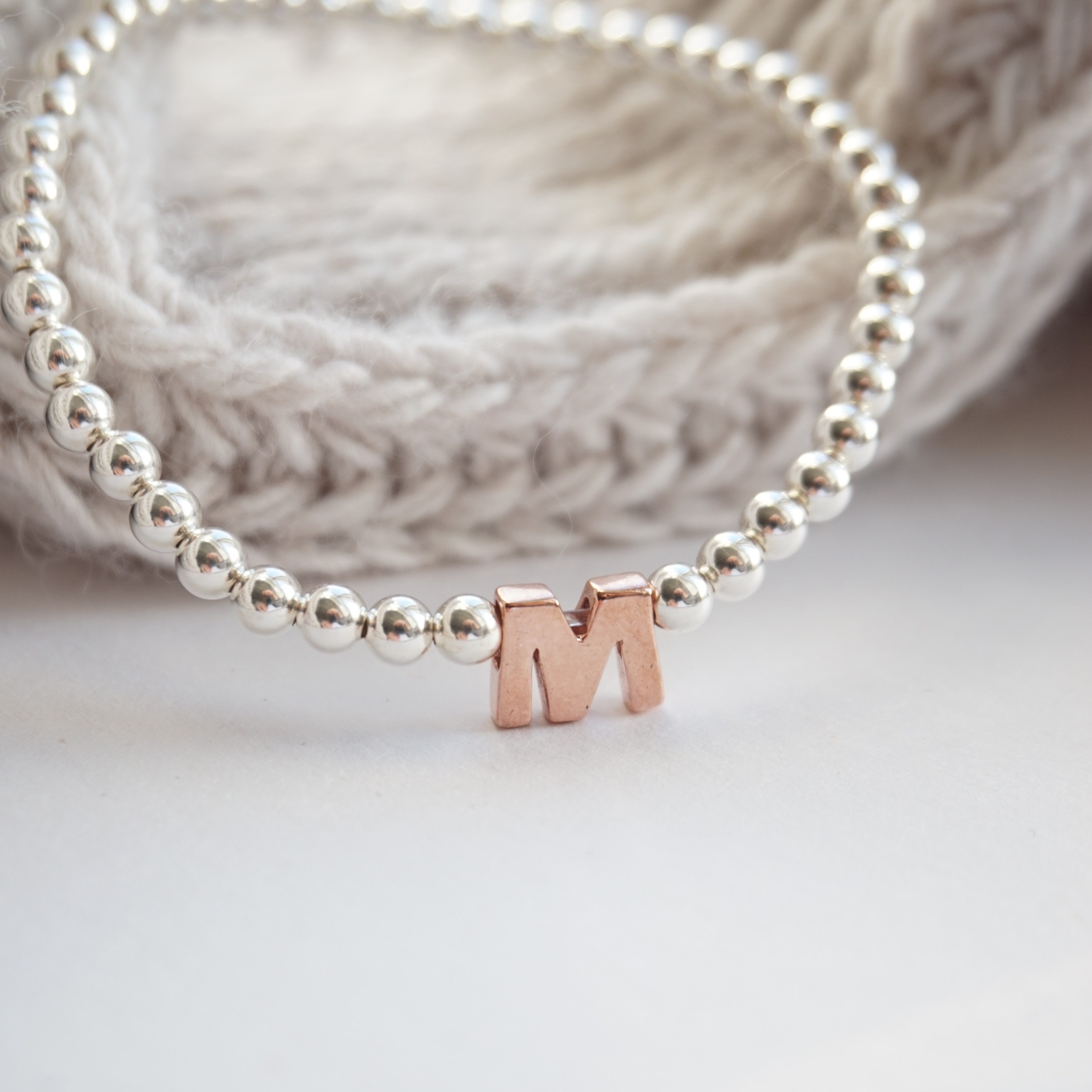 sterling silver bracelet with rose gold initial bead