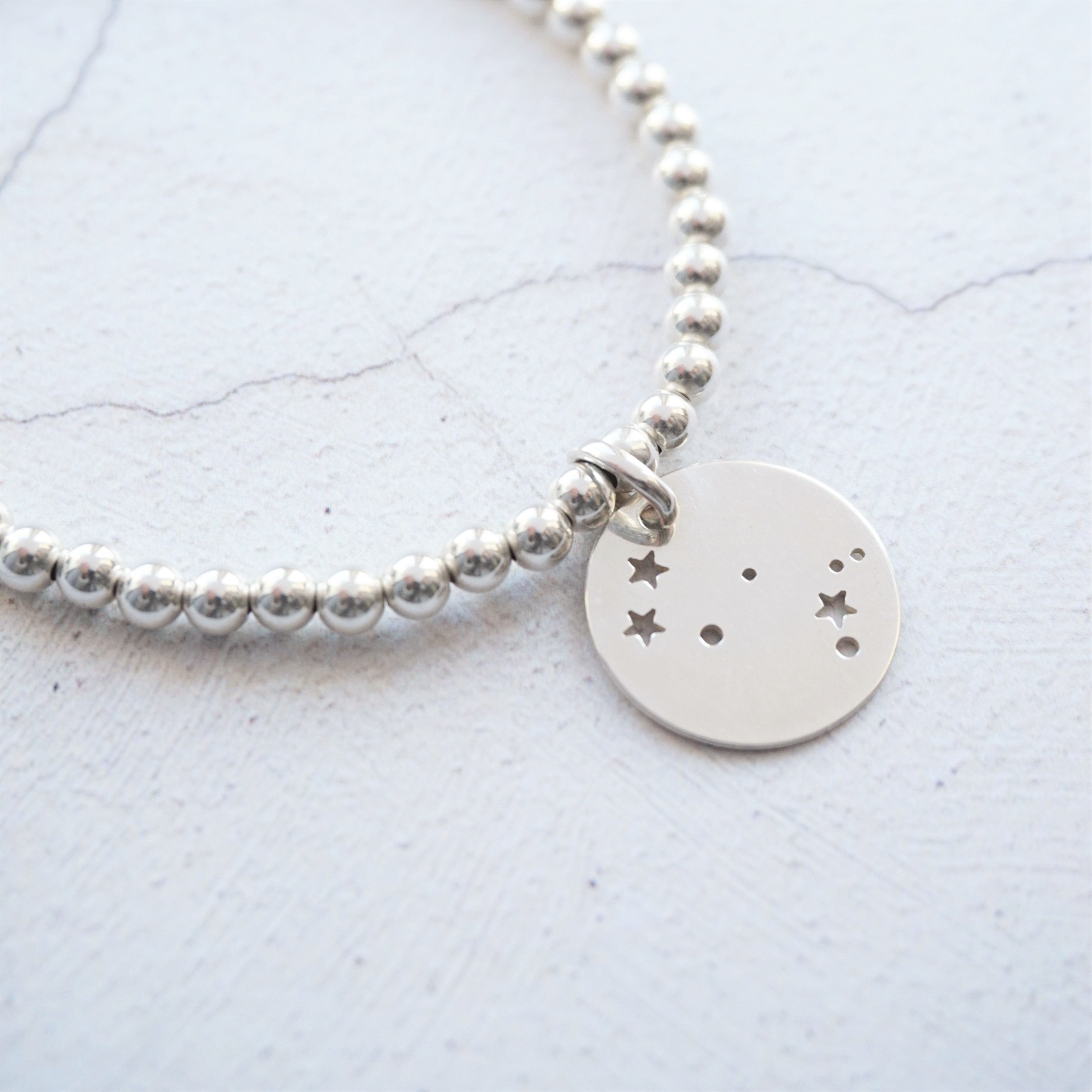 sterling silver bracelet with constellation charm