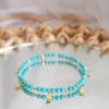 gold and turquoise bracelet with star charms