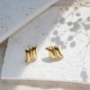 gold arc stud earrings